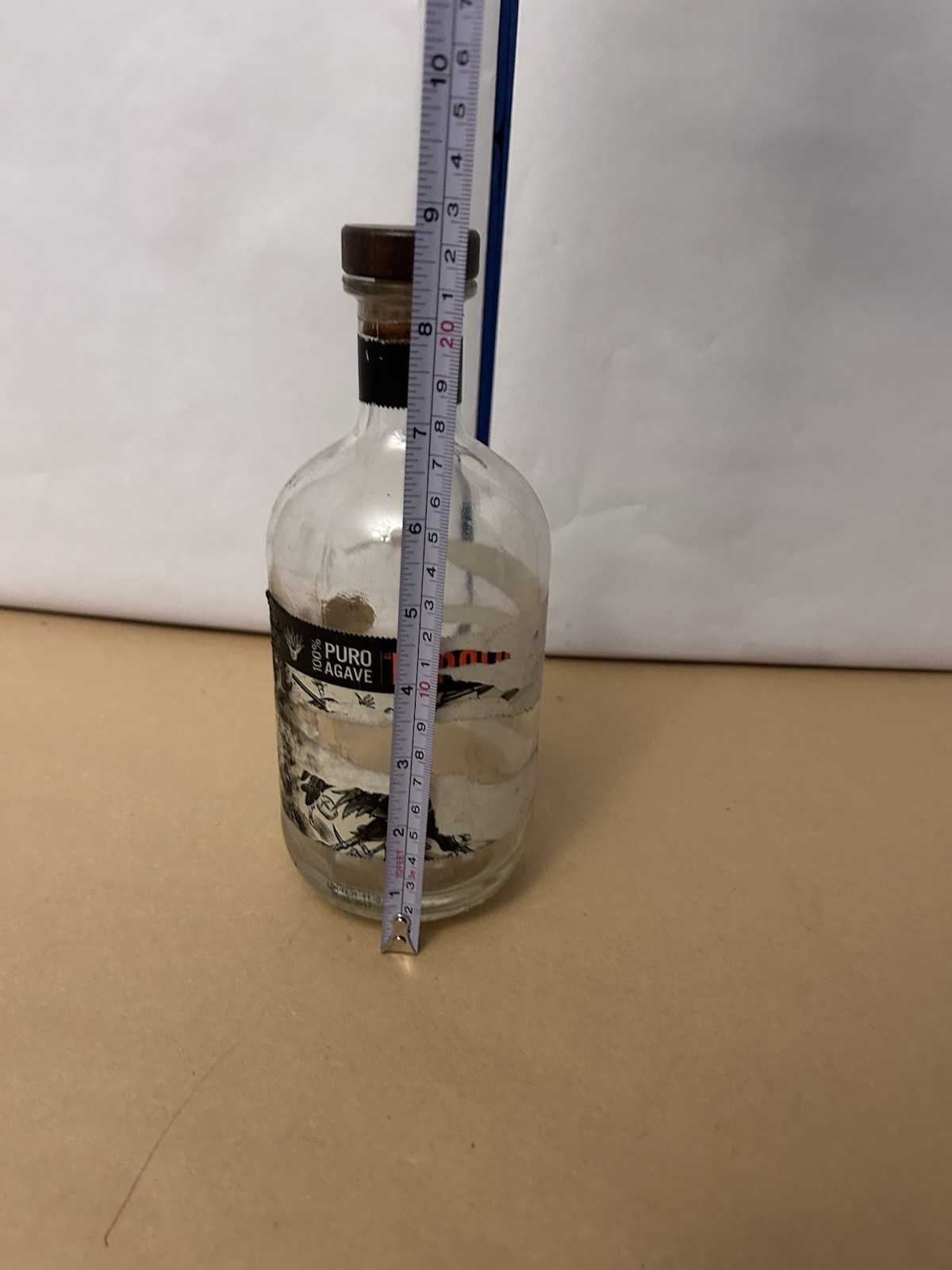 Thick Glass unbranded bottle with cork top likely tequila