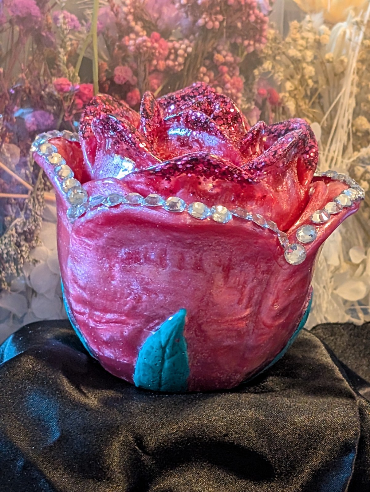 A Pink, green and rhinestone covered rose jar.  Sure to please.