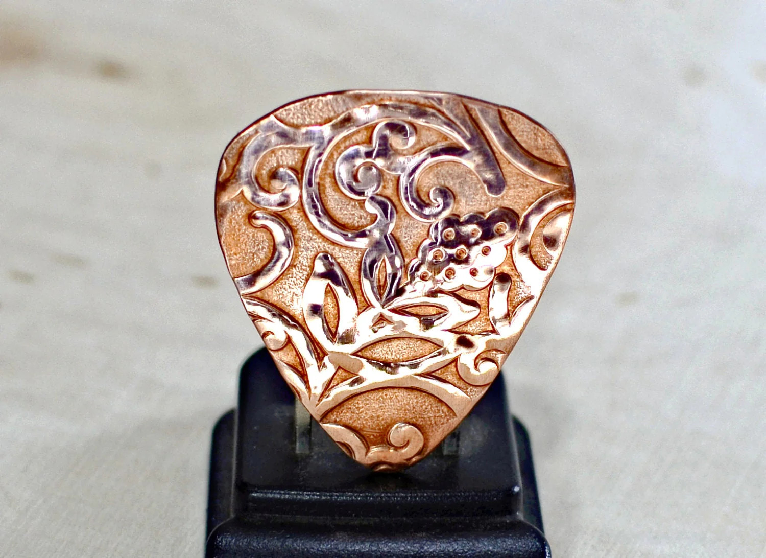 Rococo copper guitar pick with vines