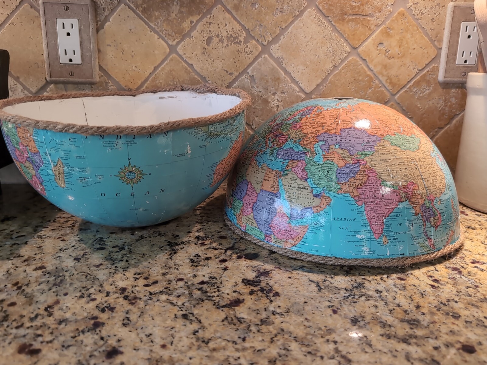 upcycled world globe pendant light fixture featuring two halves vintage globe