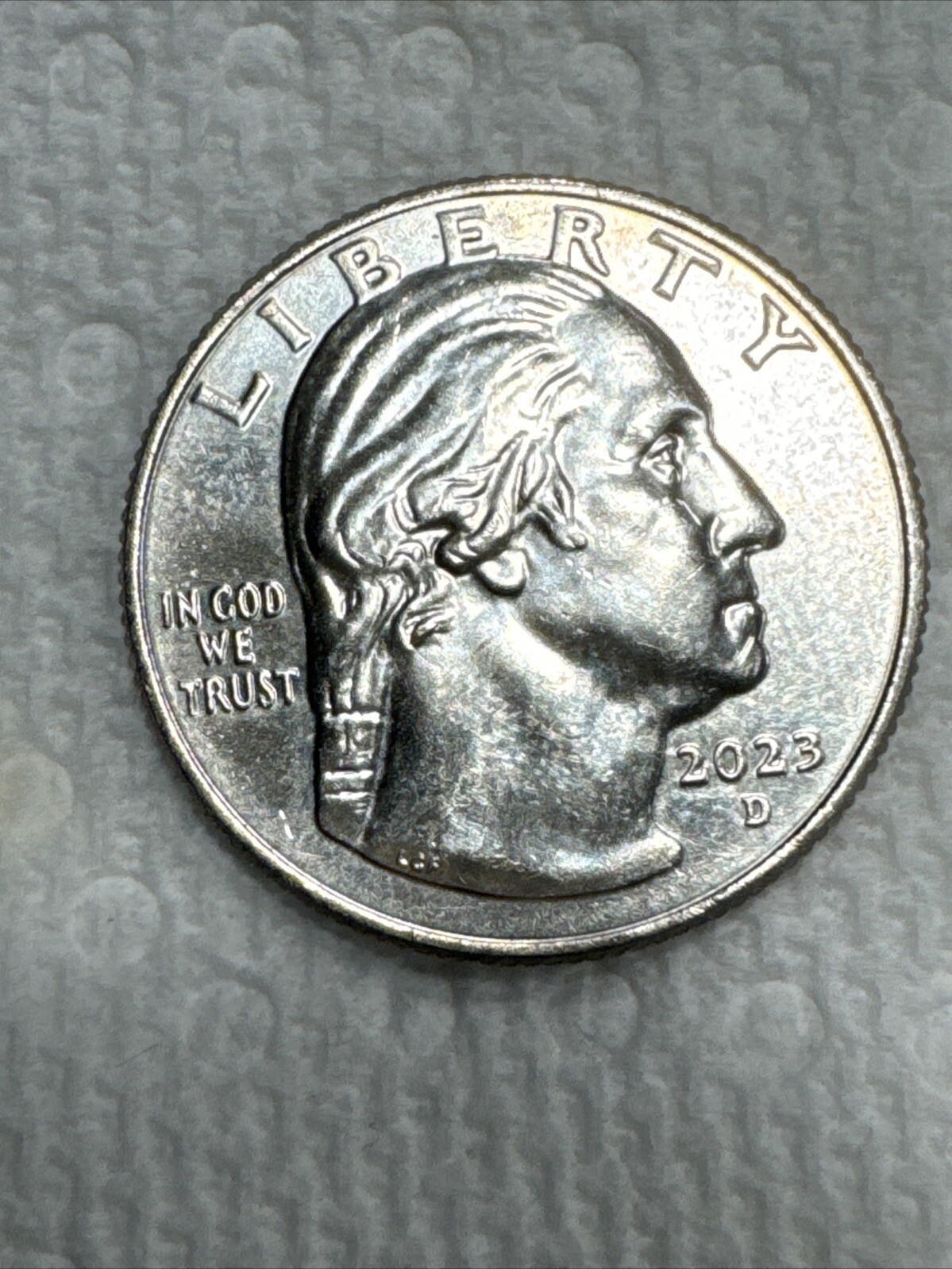 ERROR  2023 P -Jovita Idar women’s quarter reads  “In Cod We Trust”