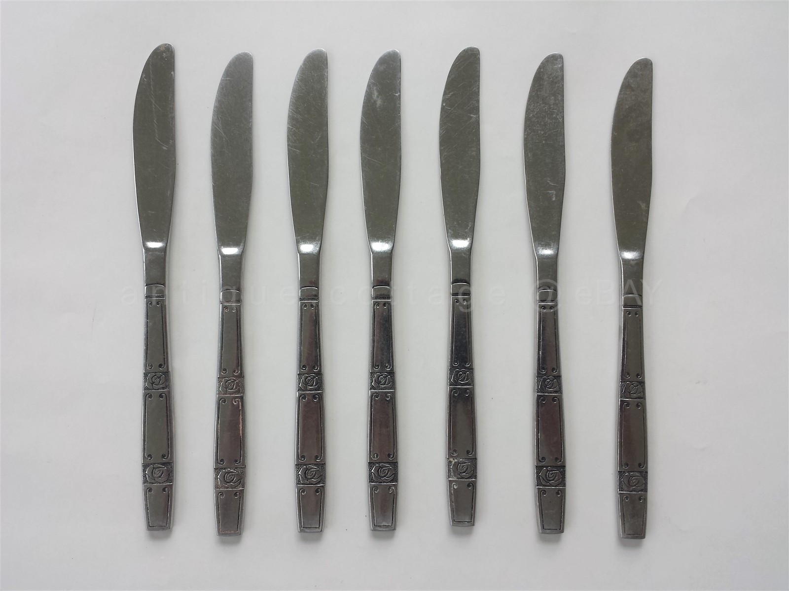 vintage OXFORD HALL ROSE COUPLET STAINLESS FLATWARE  7pc DINNER KNIVES