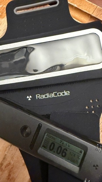 Radiacode 101 Gamma Radiation Detector Portable Dosimeter with green arm band.