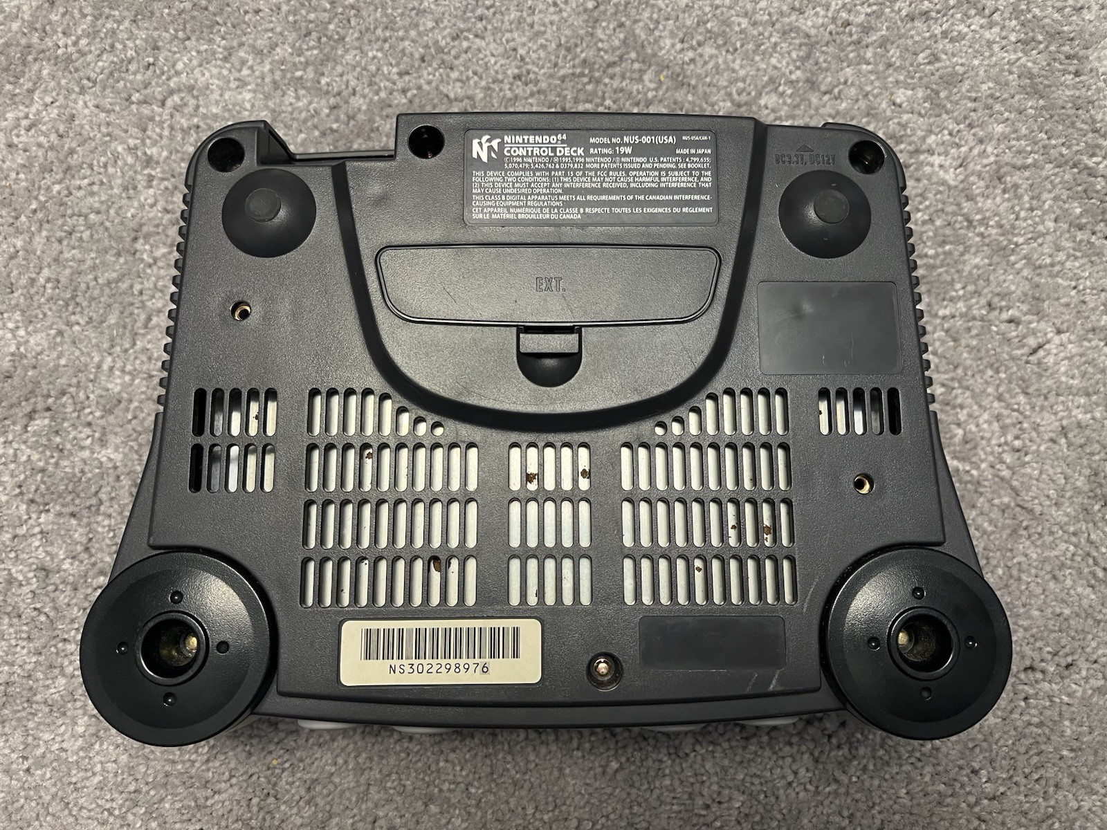 Nintendo 64 with black controller, AV cables, and power supply.