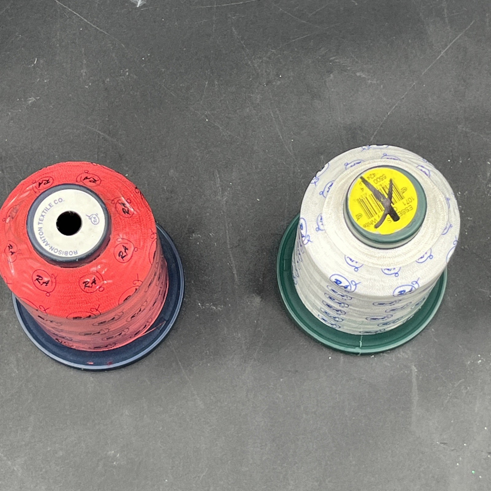 Embroidery machine thread spools red and white