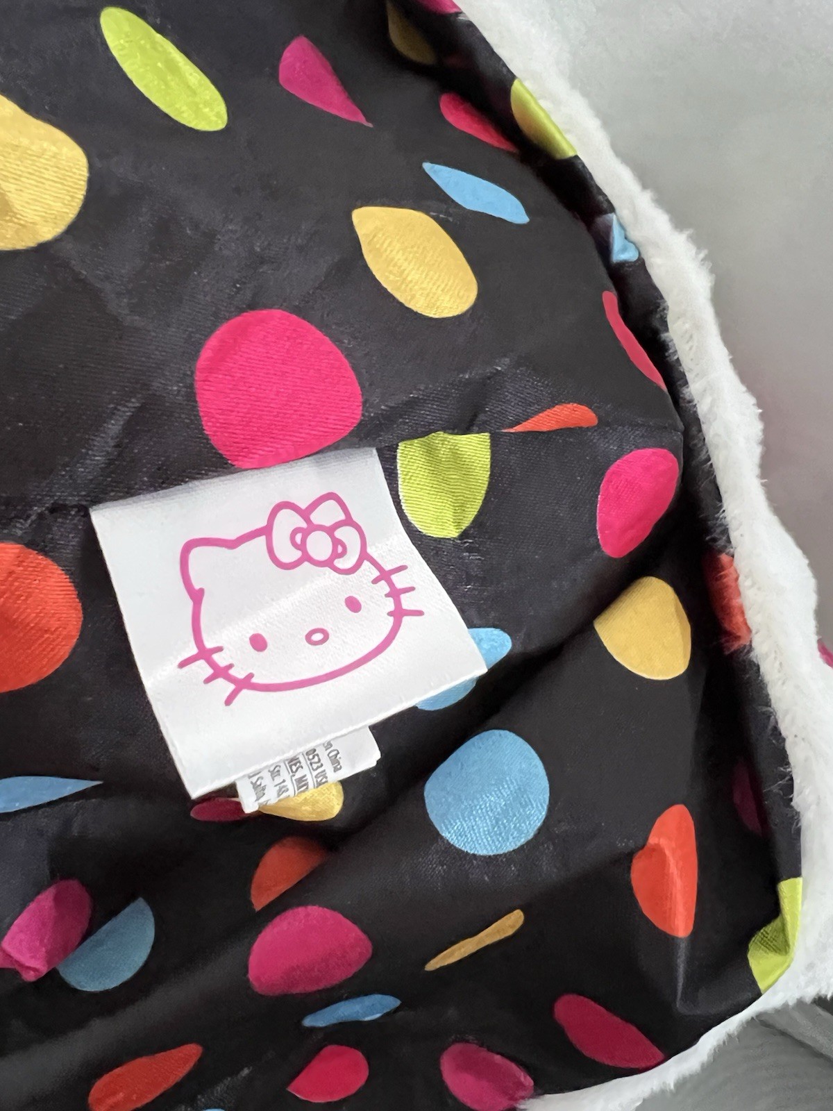 Hello Kitty Hat Hood in white with a pink bow and a polka dot lining.