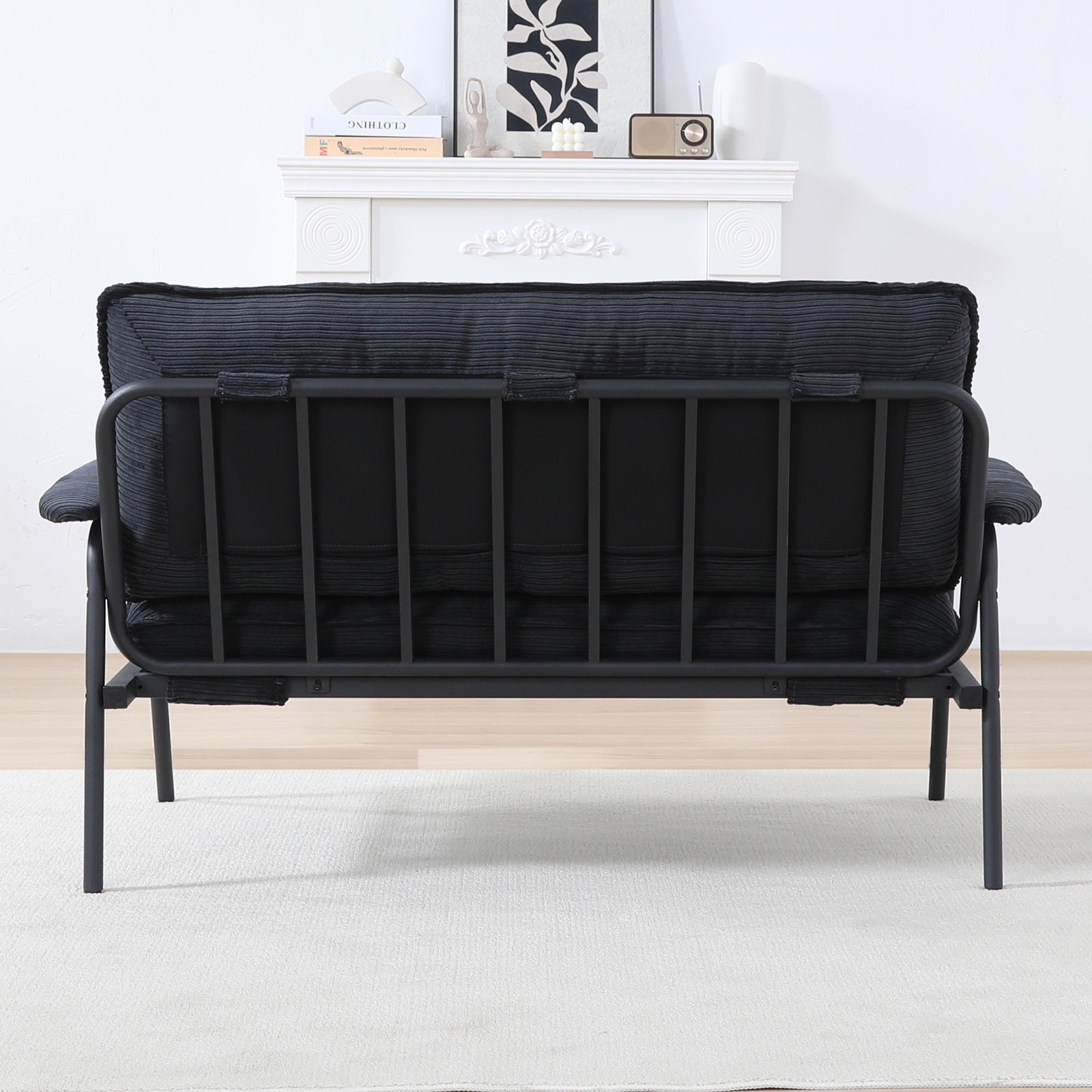 The 53-inch black sofa offers a spacious layout in the small apartment, easily