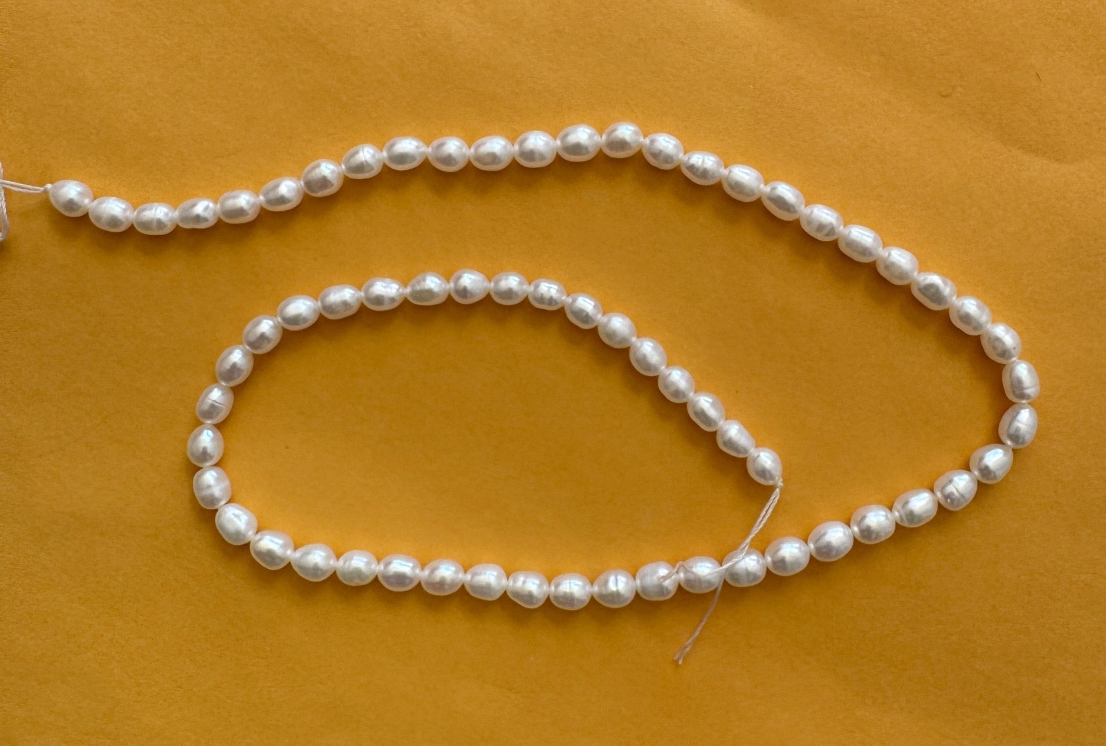 A full string of 15"  fresh water pearl, oval , white , 5-6 mm