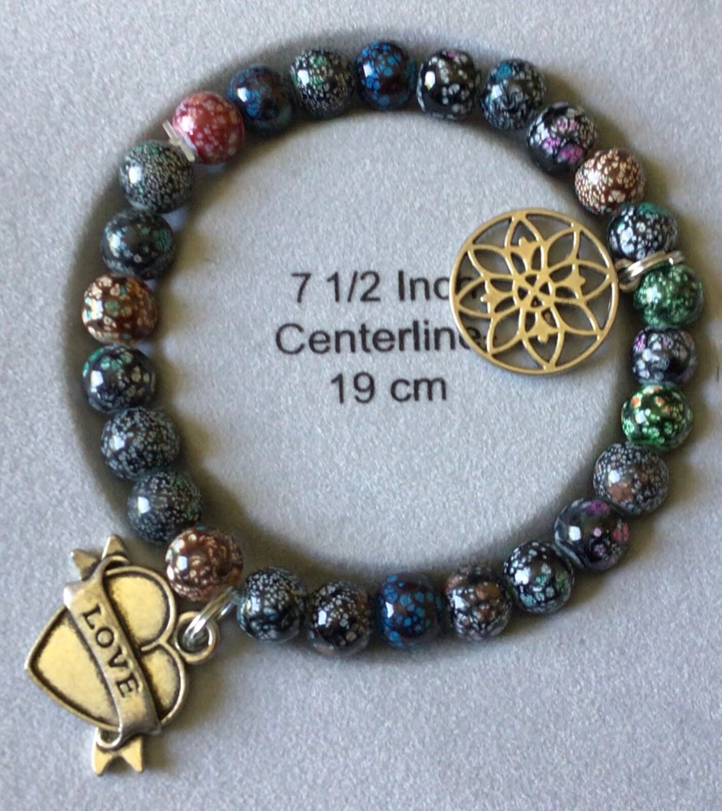 7.5" bracelet, multicolored beads w/2 charms, made in the USA