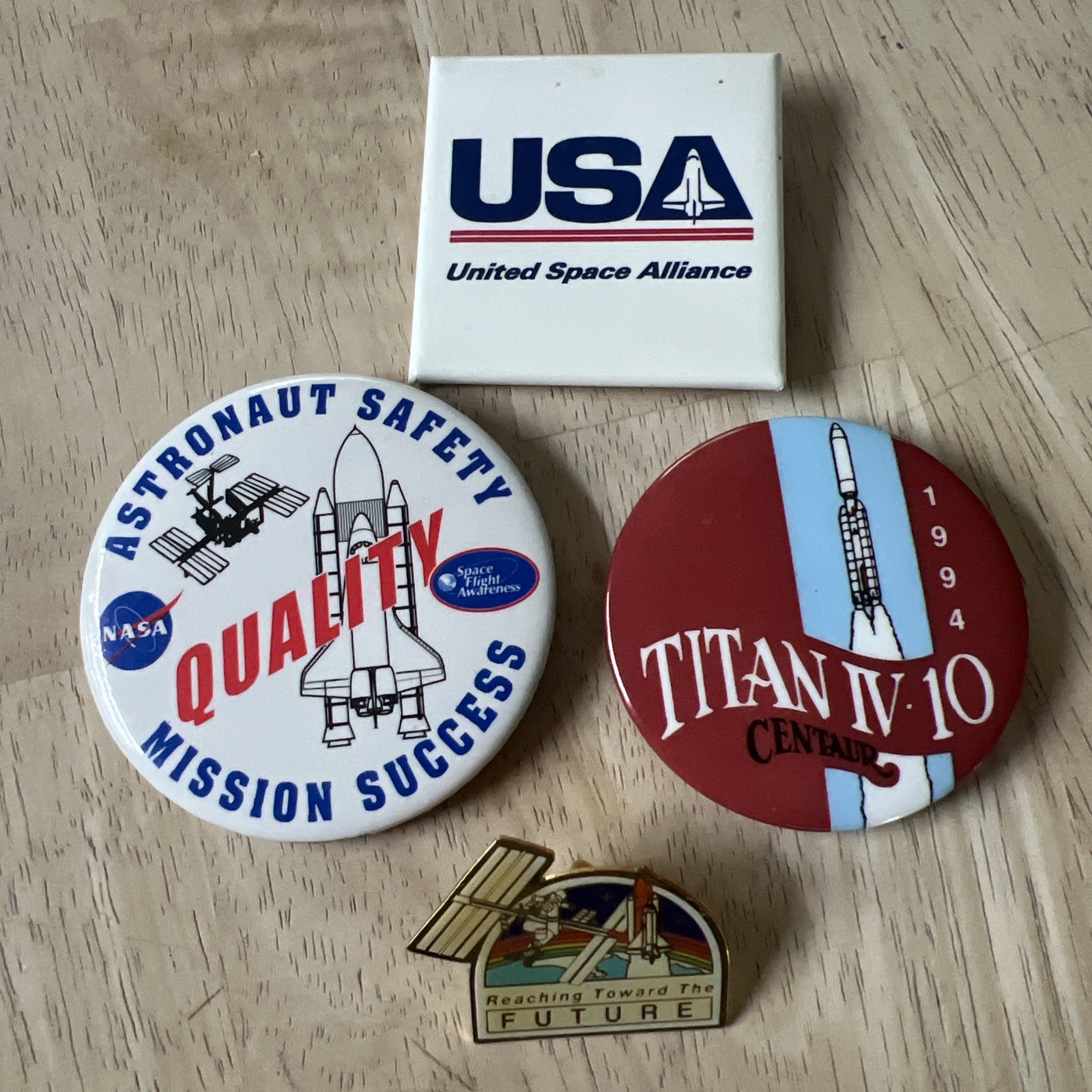 four vintage aerospace memorabilia pins and buttons from the 1990’s Era