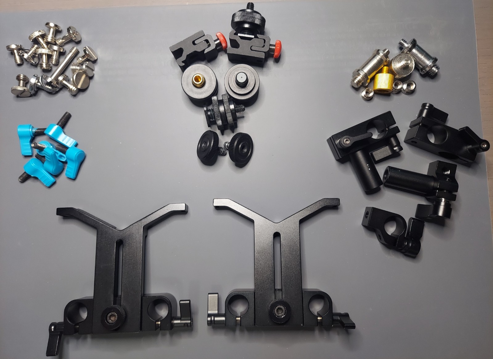 Assort of hardware for camera mount rig: adaptors, screws, lens support and more