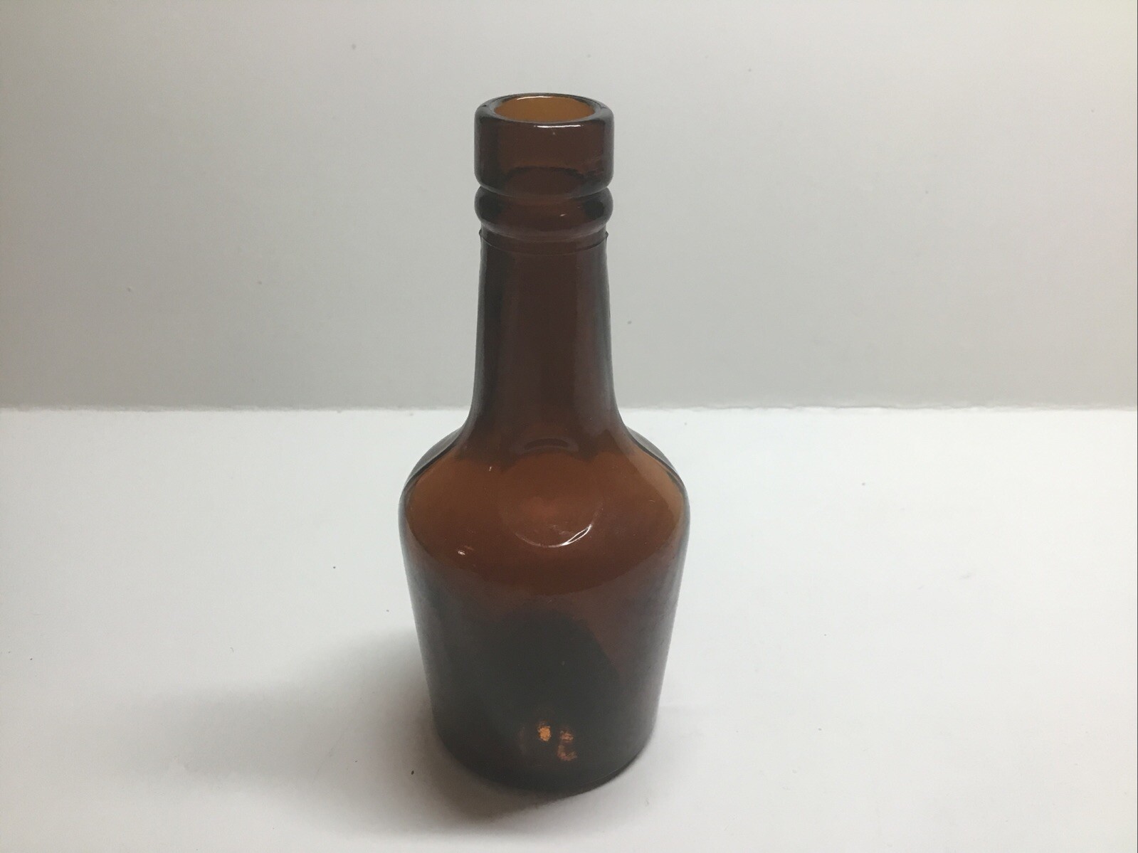 Small Squatty Antique Amber Sample Liquor Bottle.