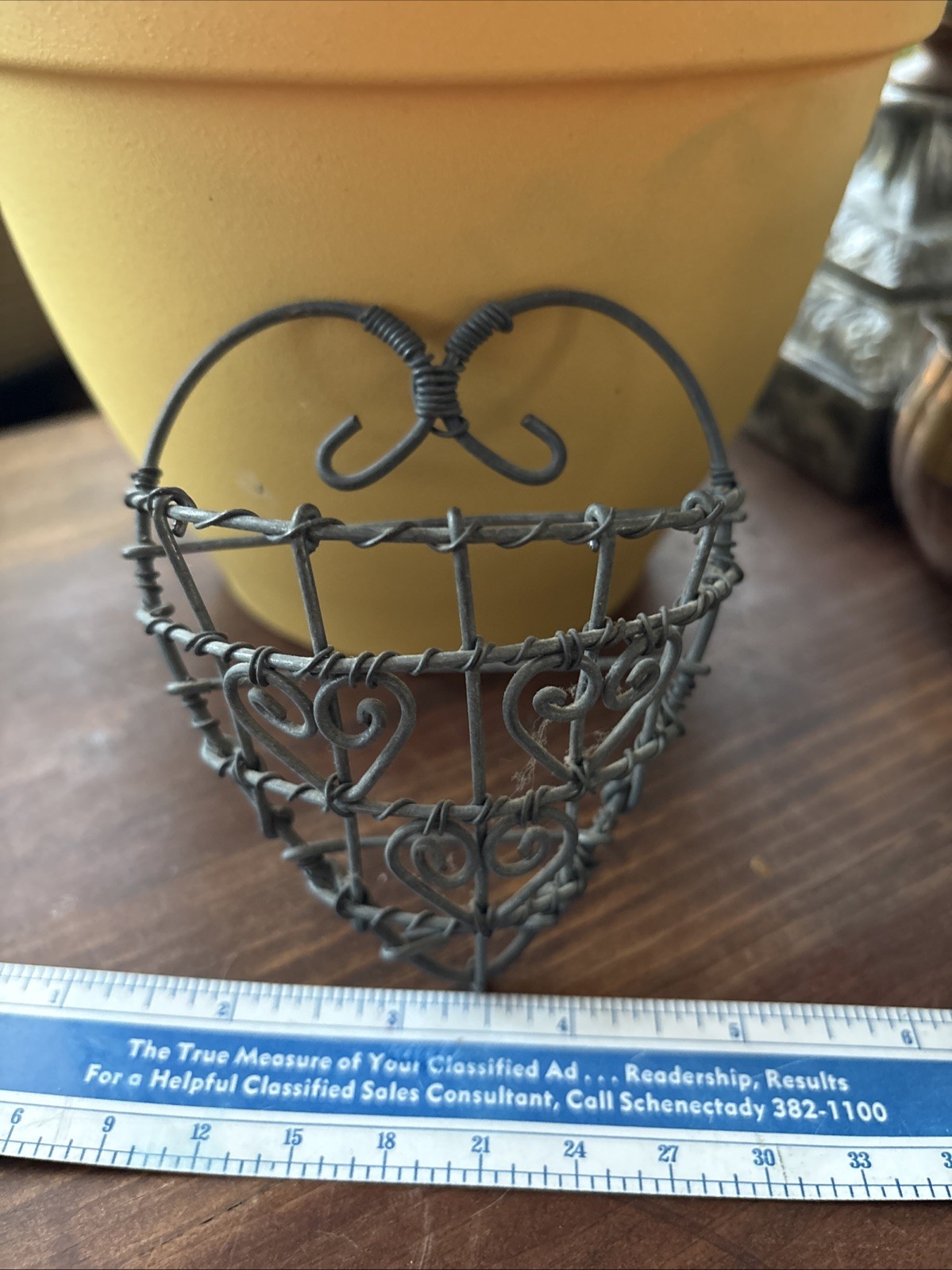 rustic, heart-shaped wire basket with scrollwork details.