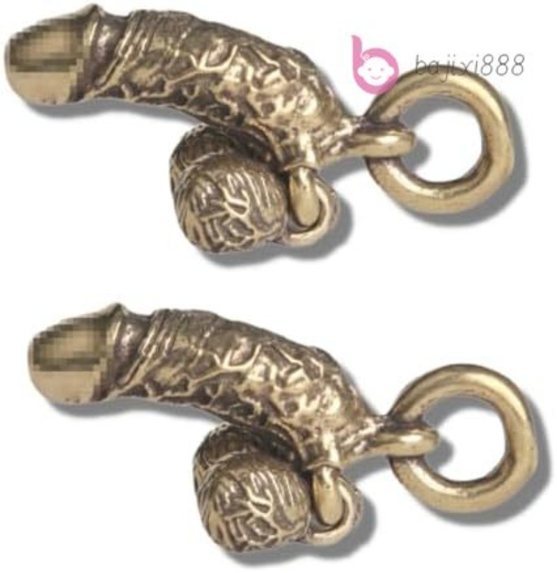 A pair of vintage brass spoof fun genital keychain pendants
