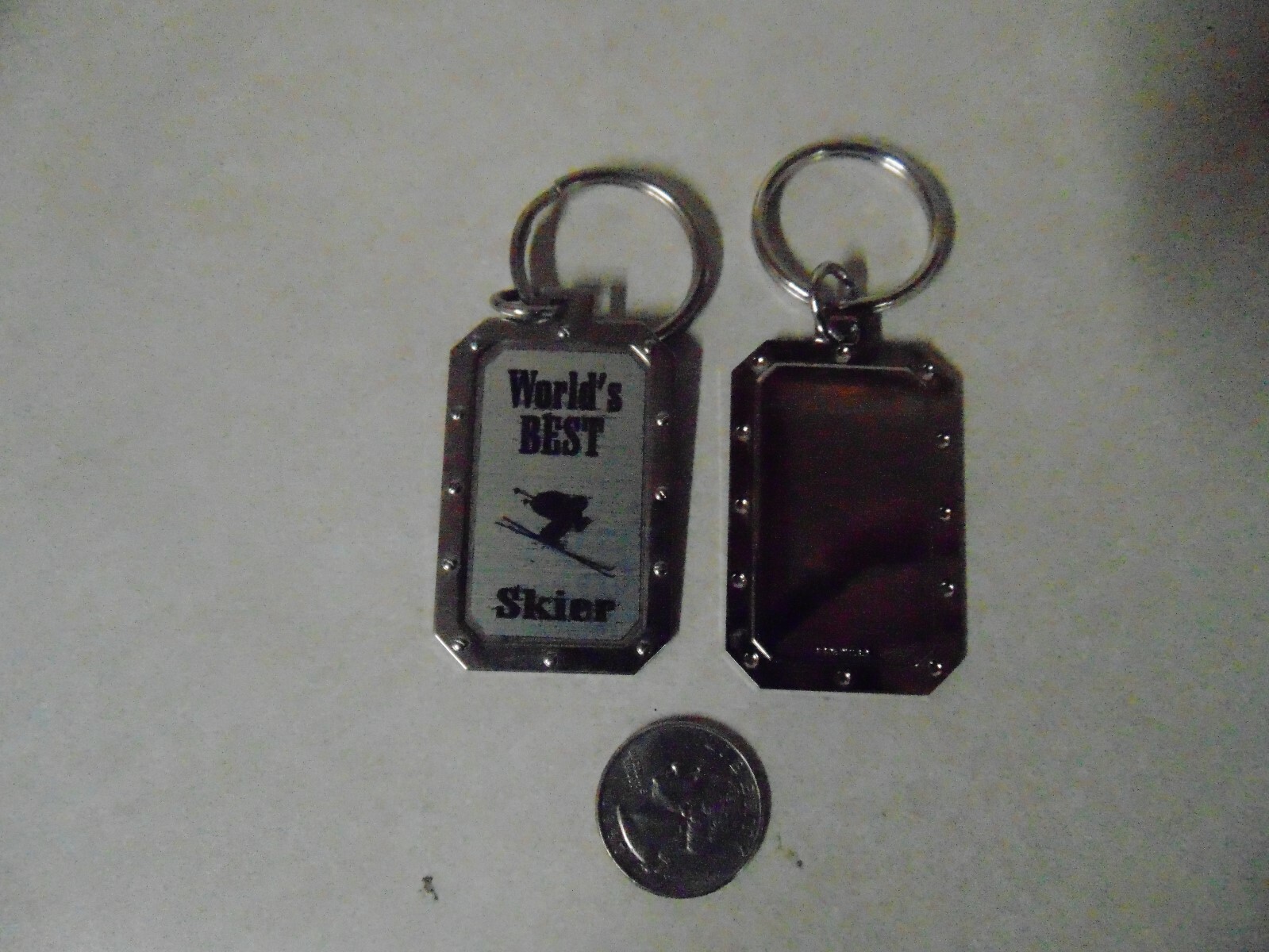 DOG TAG SHAPED KEY CHAIN WORLDS BEST SKIER ABOUT 2 INCHES