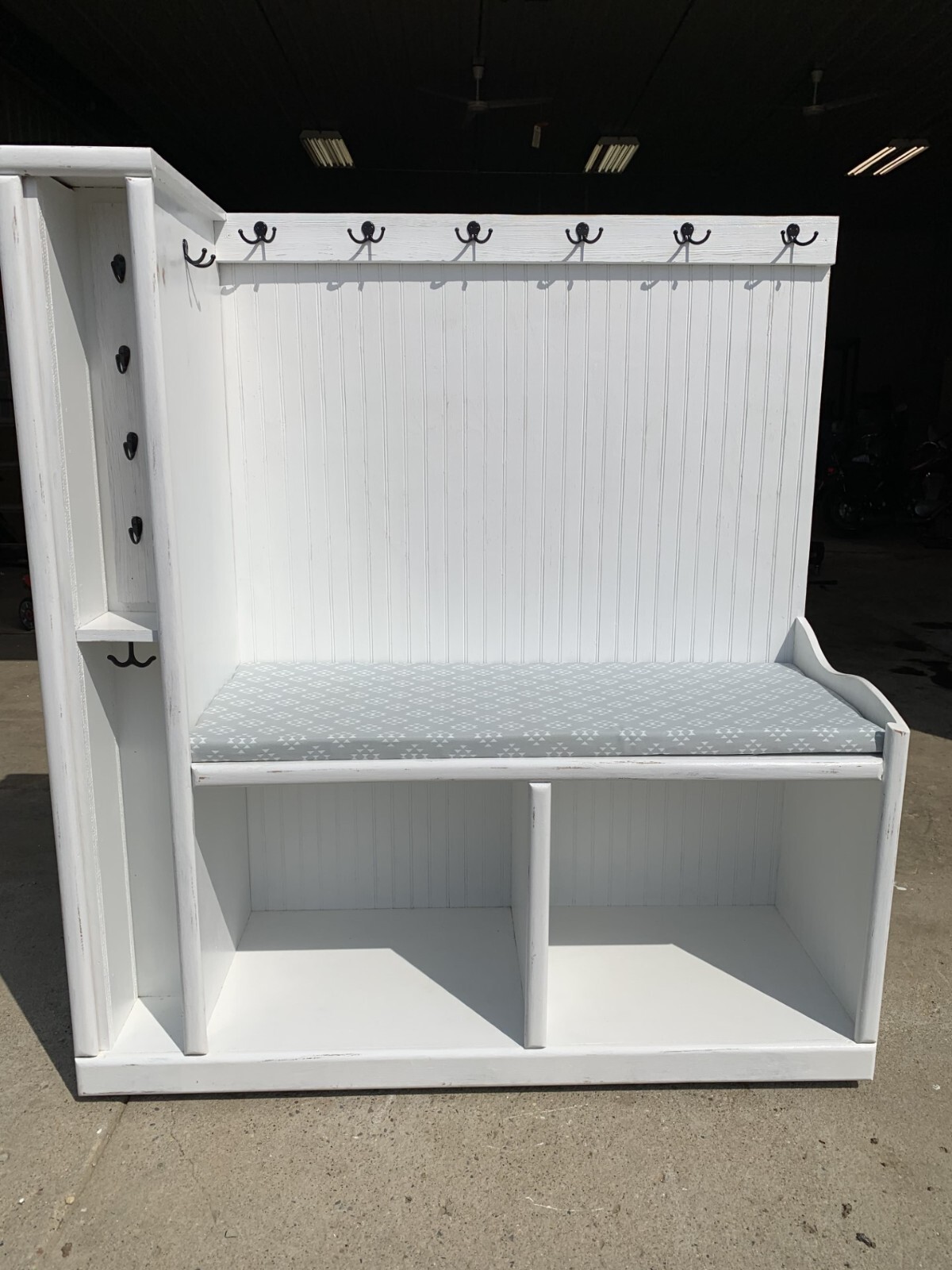 entry way bench with seat, coat hangers, and extra storage