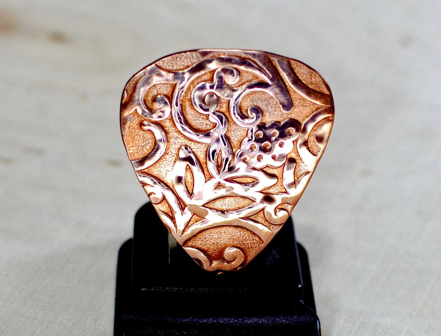 Rococo copper guitar pick with vines