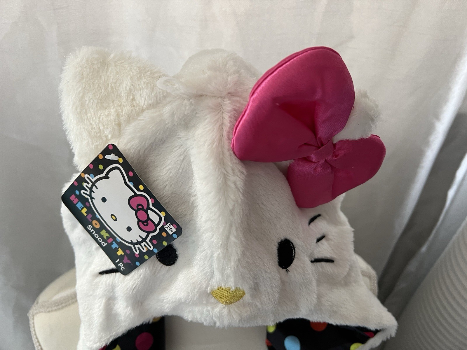 Hello Kitty Hat Hood in white with a pink bow and a polka dot lining.