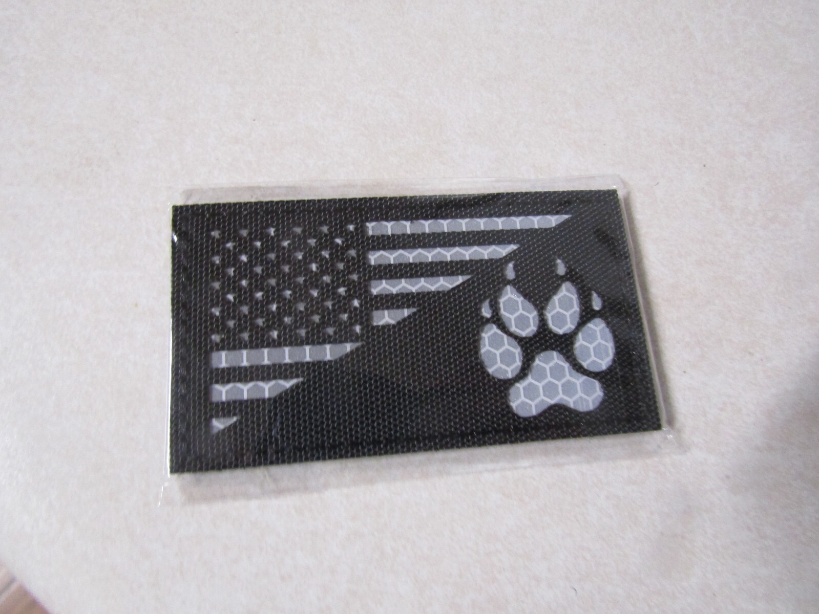 FLAG PATCH HOOK & LOOP APPROX 2 BY 3 1/2 IN K-9 UNIT DOG PAW BLACK WHITE WRITING