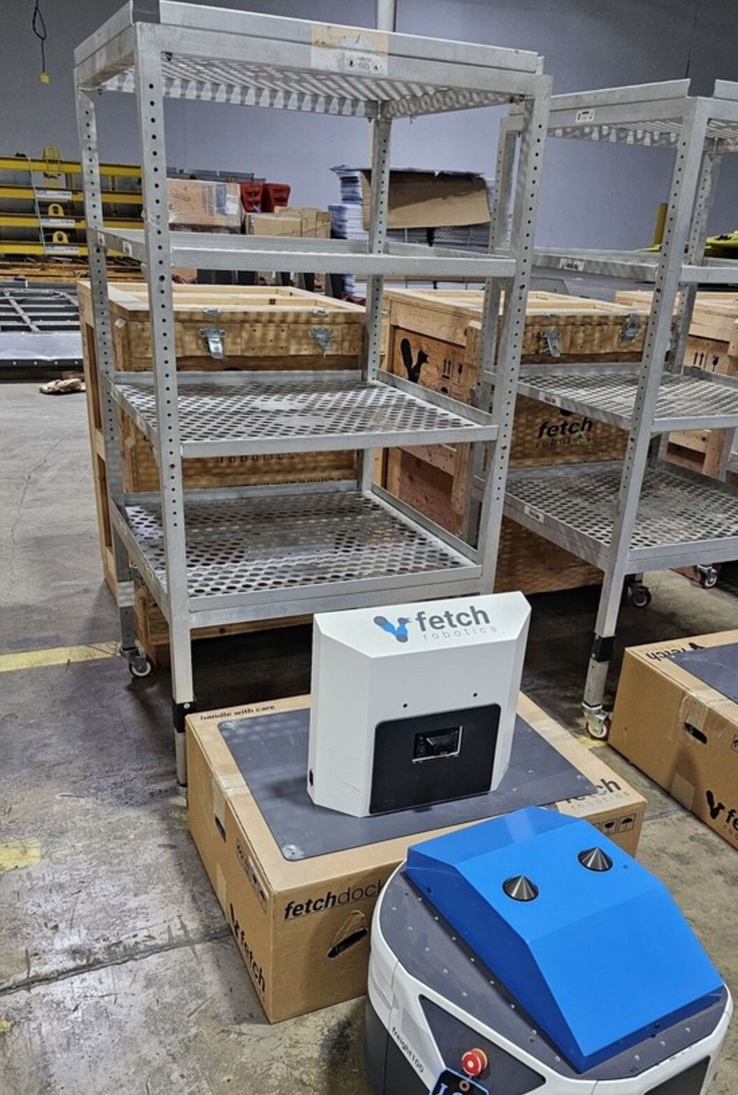 Zebra Fetch Robotics Freight 100 AMR With tall transfer cart & charger.