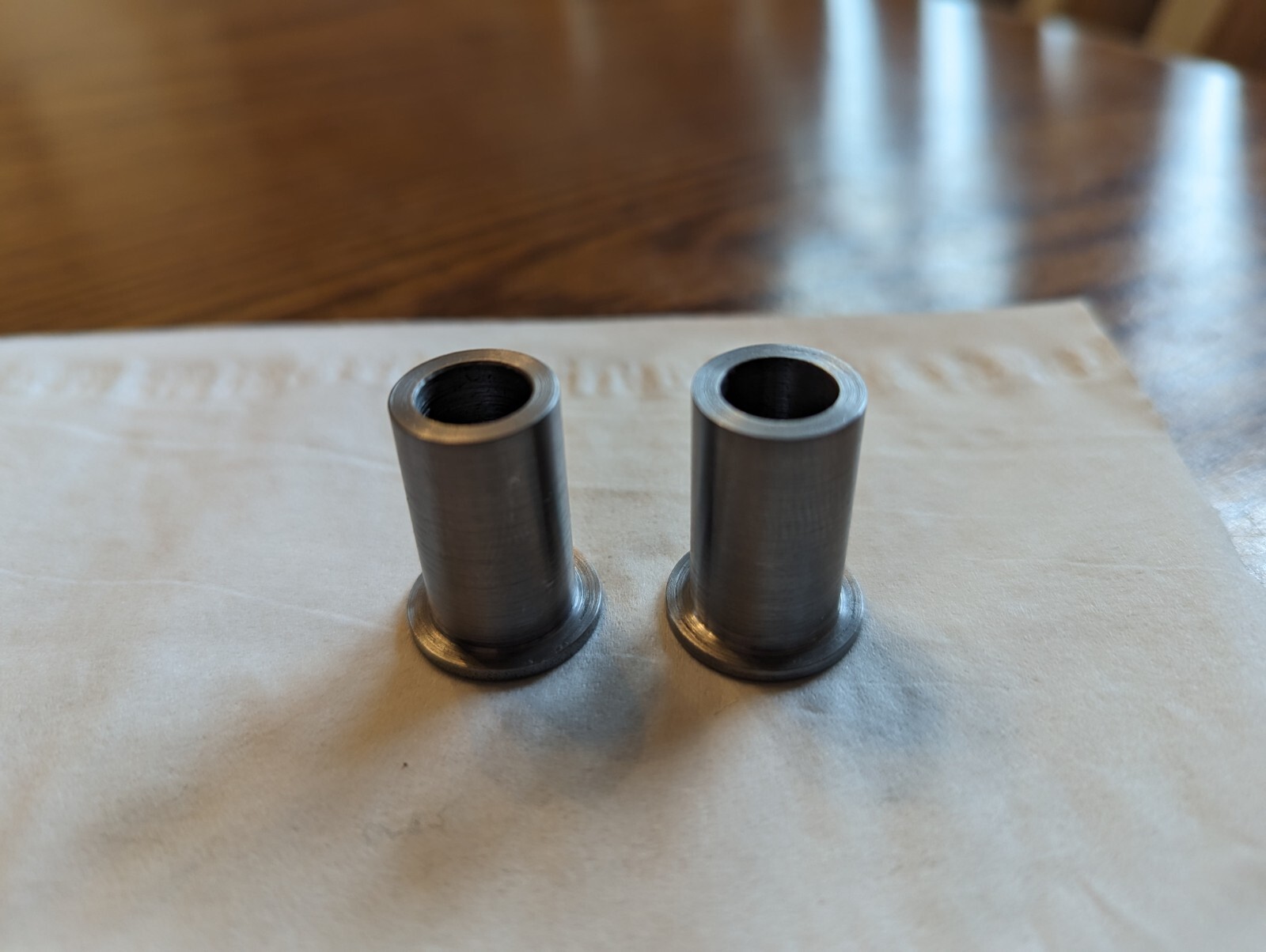 FLANGED STEEL BUSHING, 3/8 ID, 9/16 OD, 1 INCH LONG. TWO PIECES.