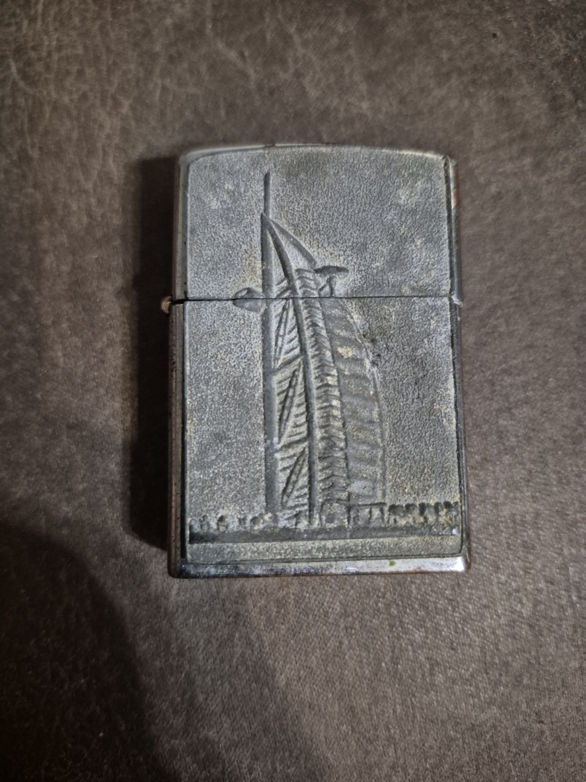 This is a Zippo lighter featuring an embossed design of the iconic Burj Khalifa