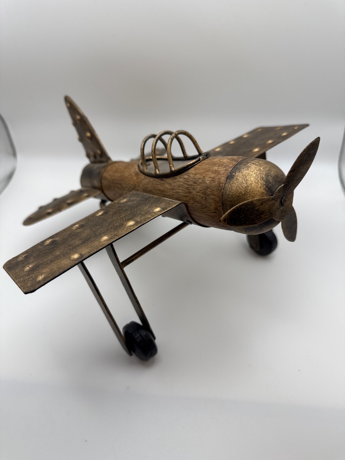 wood and metal decorative airplane model with aged bronze finish