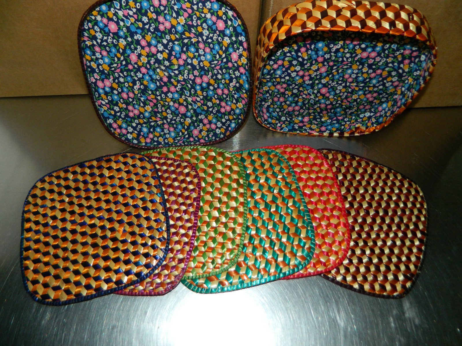 Six basket weave trivets in a matching basket