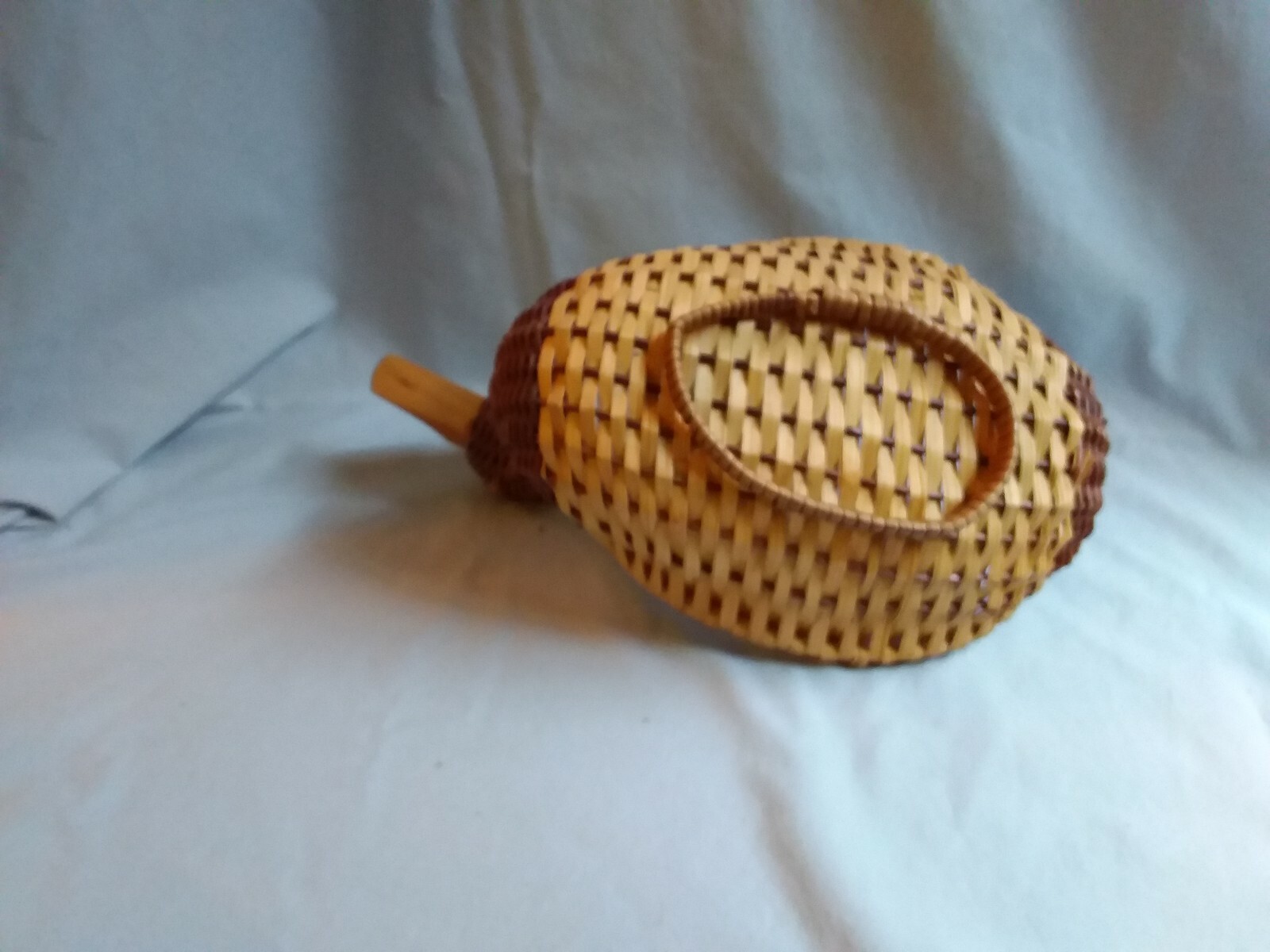 Woven straw basket shapped as a duck with a wooden beak