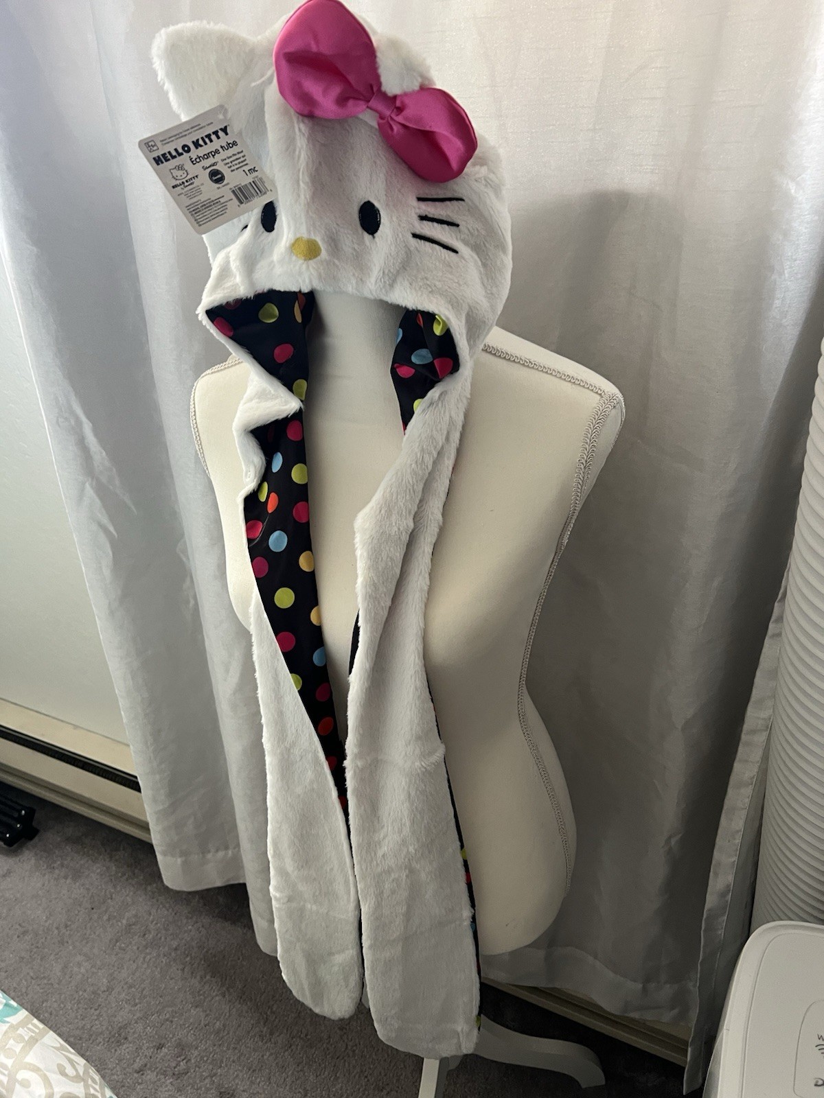 Hello Kitty Hat Hood in white with a pink bow and a polka dot lining.