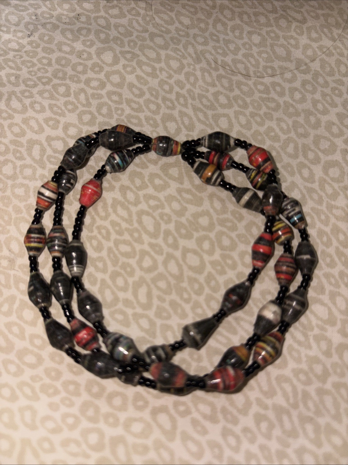 fun! 3 strands paper beaded bracelet , variety of colors and a beautiful piece.