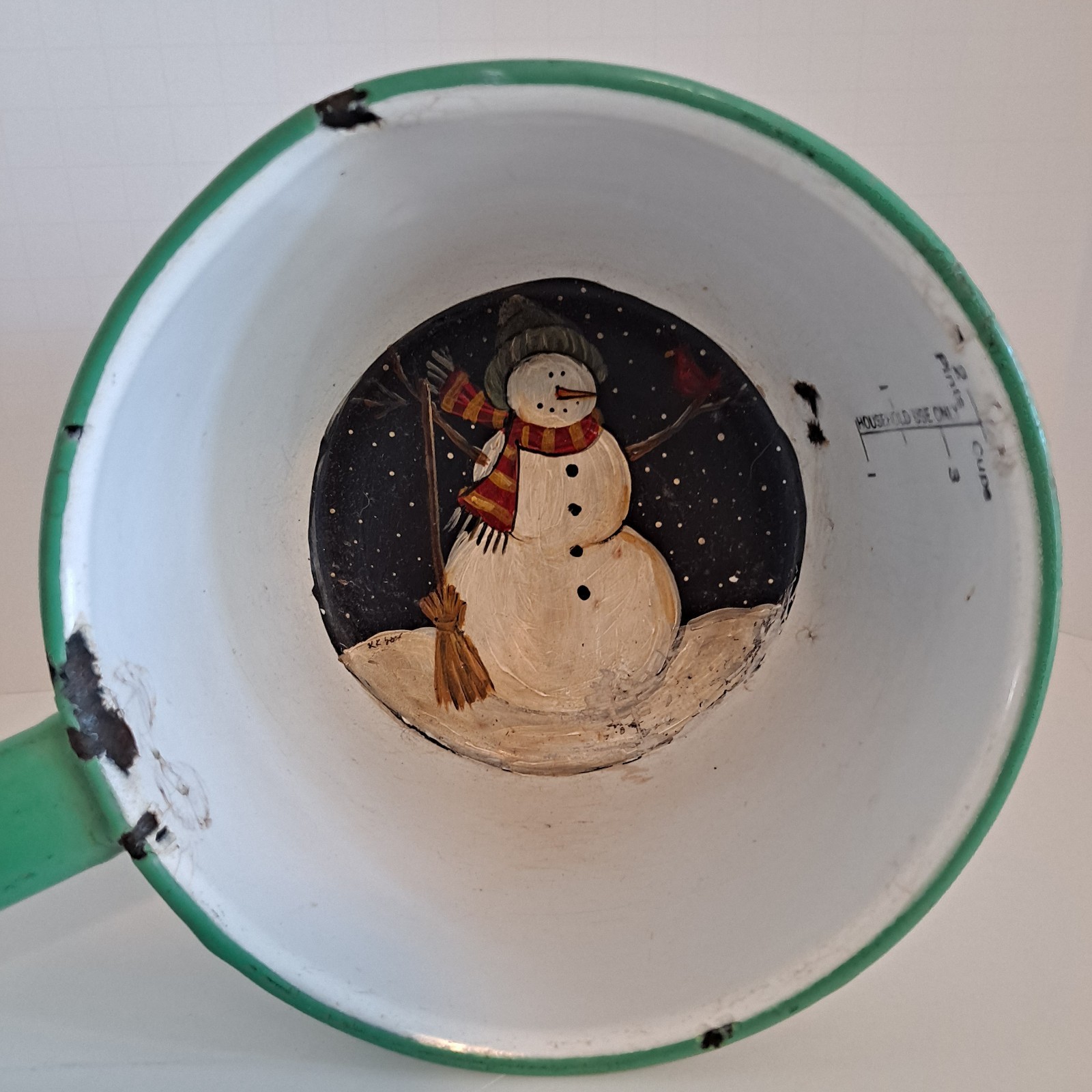 Well used enamel ladle given new life with a cute snowman painted on the bottom