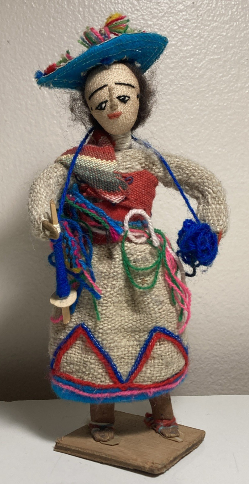 handmade folk art doll, likely a souvenir from Peru