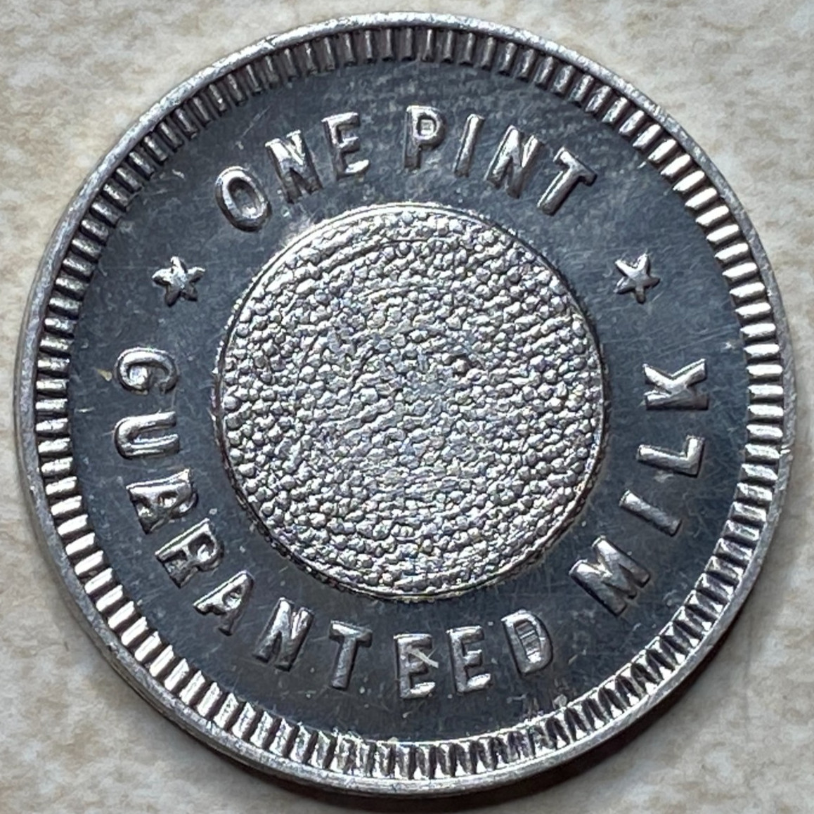 T9259 One Pint Guaranteed Milk, Unknown  Anillo Restrike Arcade Token