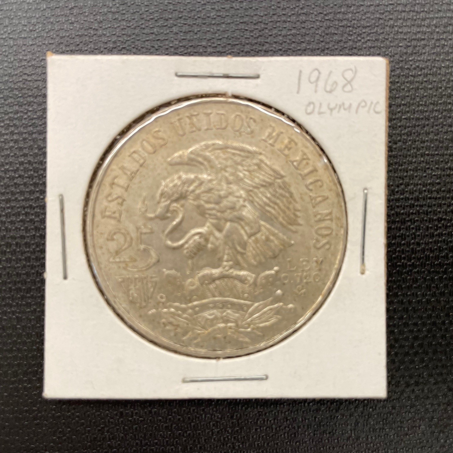 1968 MEXICO 25 PESOS SILVER COIN WITH OLYMPIC GAMES LOGO IN PAPER SLEEVE