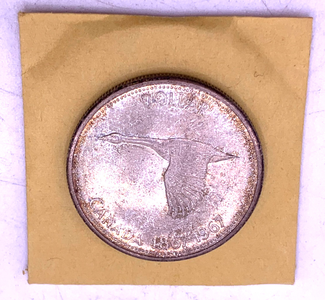 1967 Canadian Silver Dollar Toned in original yellow envelope sleeve