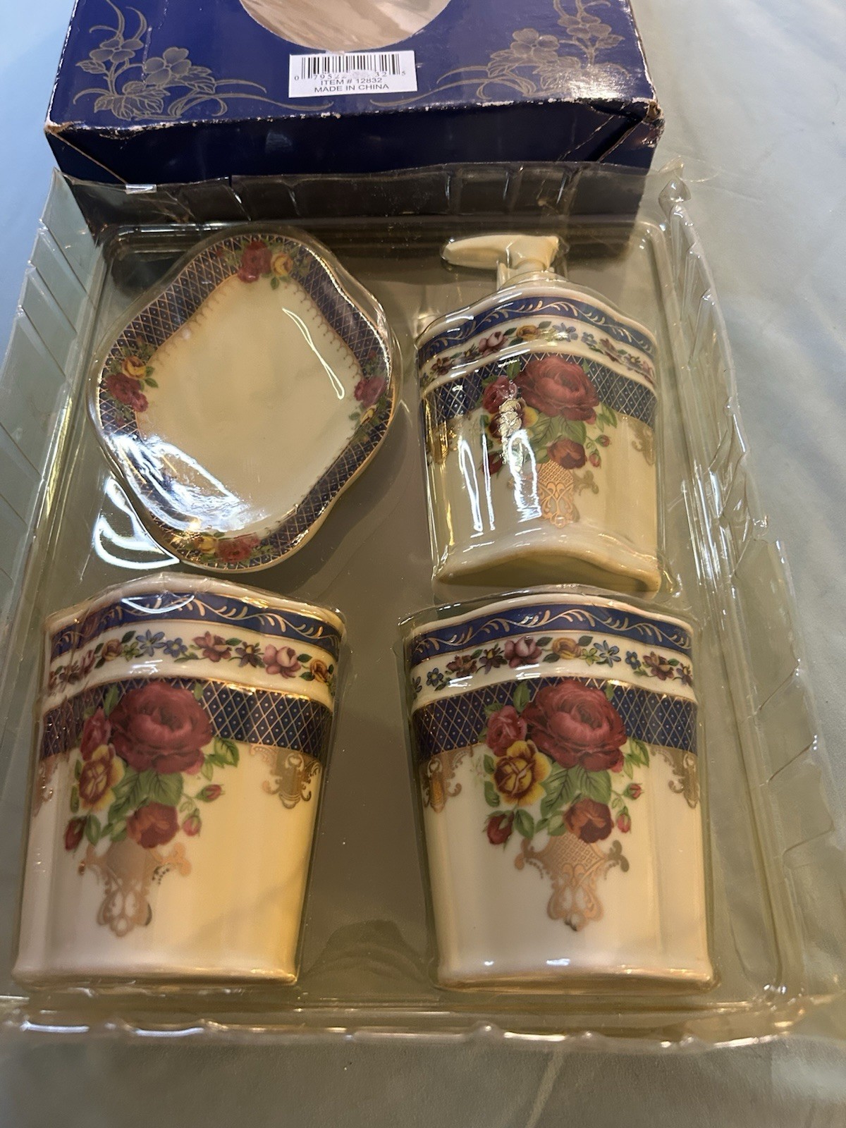 four-piece floral porcelain bathroom set never opened but toothbrush cracked