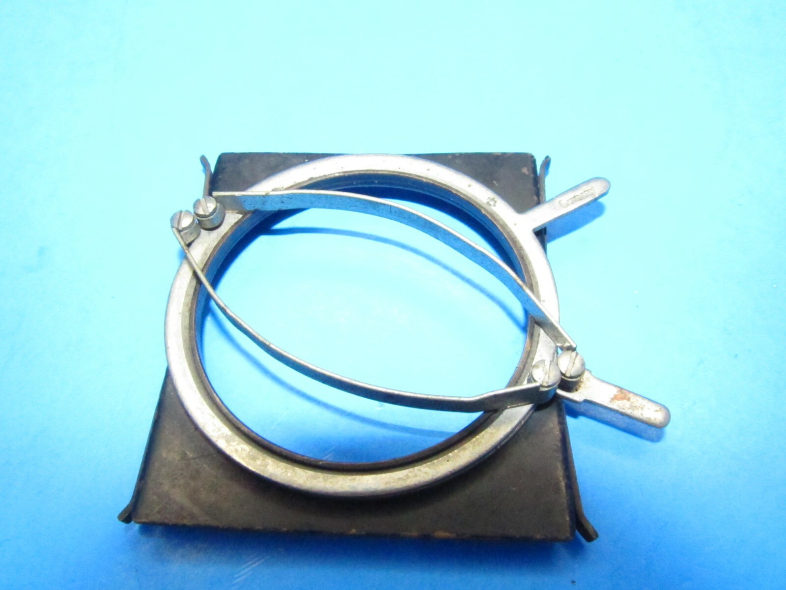 unique small filter holder marked RHACO DRP GERMANY attaches w/ spring clamps