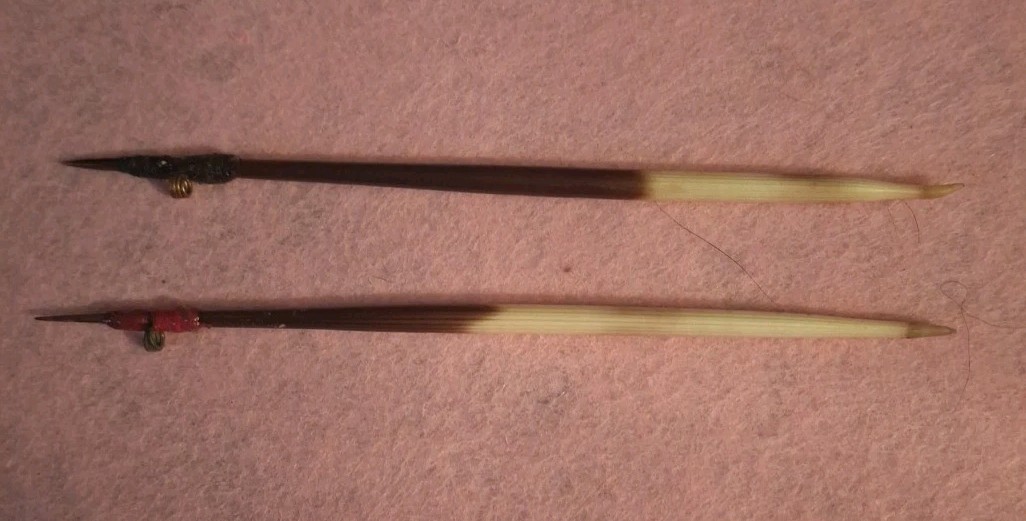 TWO HANDCRAFTED PORCUPINE QUILL FLOATS