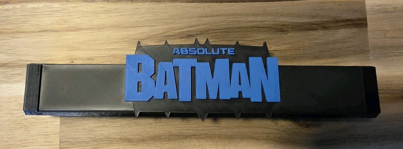 Absolute Batman comic book stand For Raw Comics