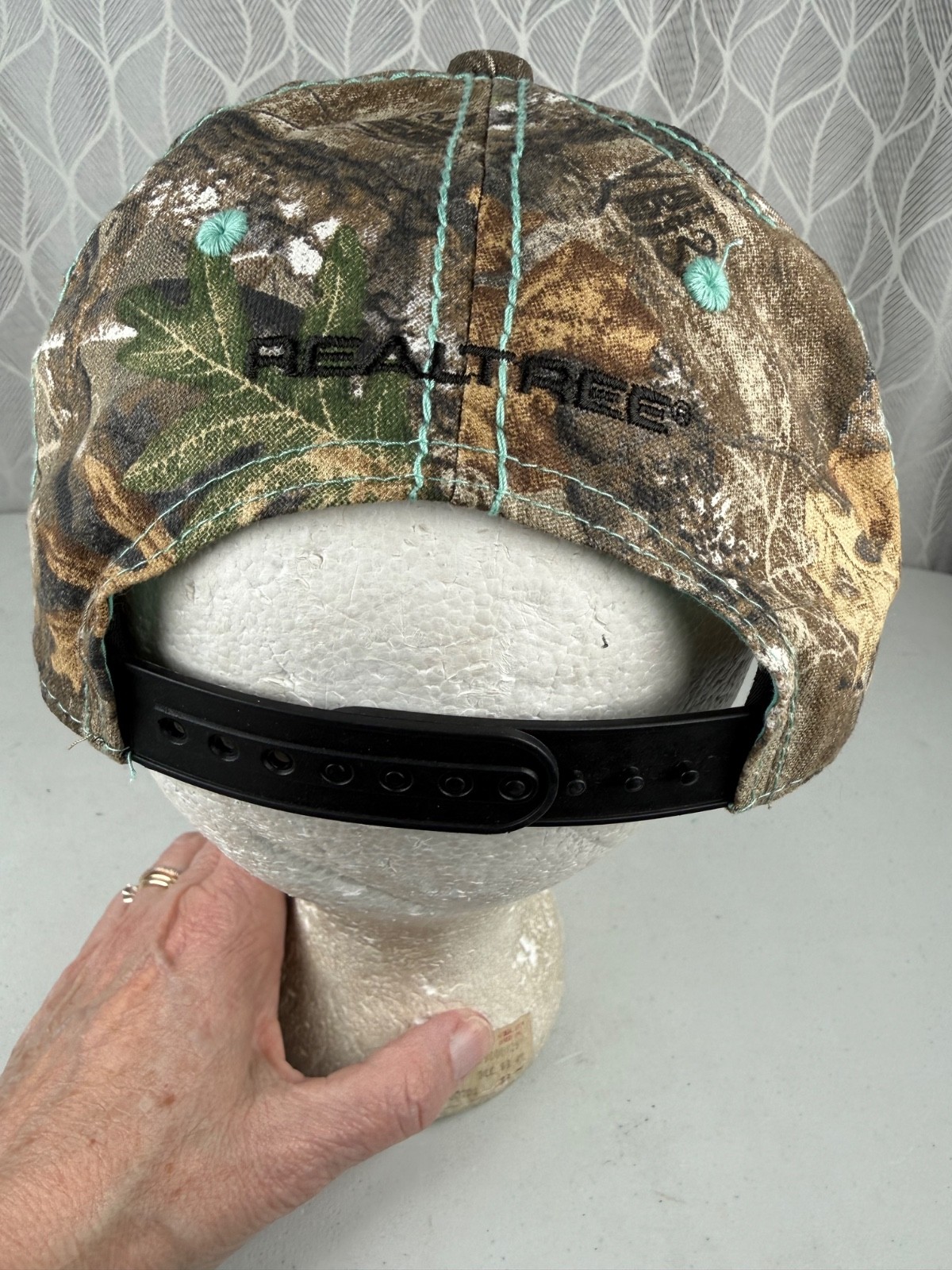 Real Tree Gold Sparkle Logo Black Aqua Rivet Patch on Camouflage Hat Cap
