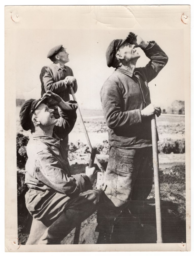 1945 German Civilians Working for British Watch Allied Air Armada News Photo