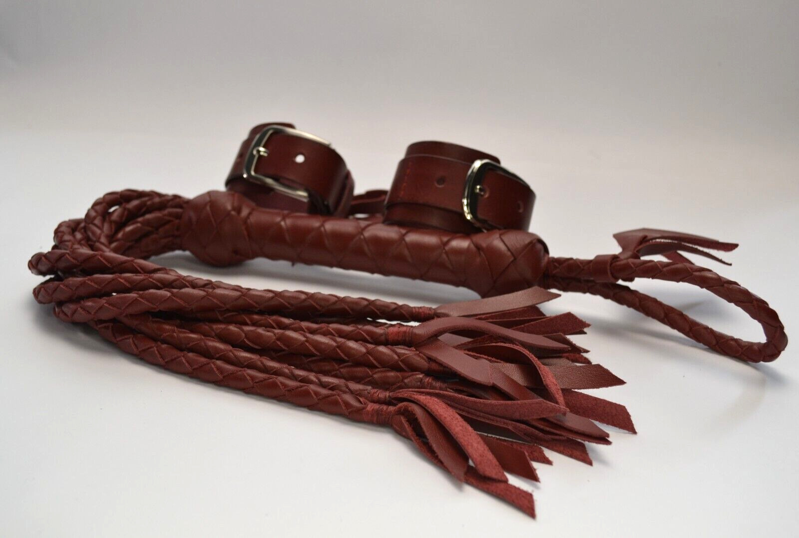 Genuine cattle leather flogger with 09 braided tails and soft ends on each tail.