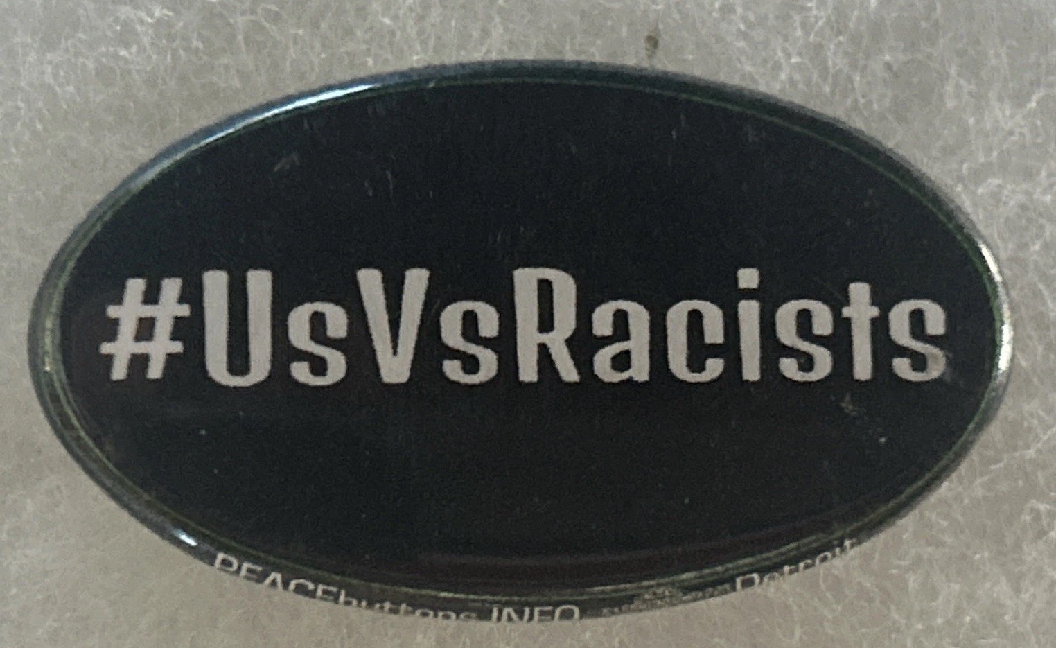 #UsVsRacists cause oval pinback button pin