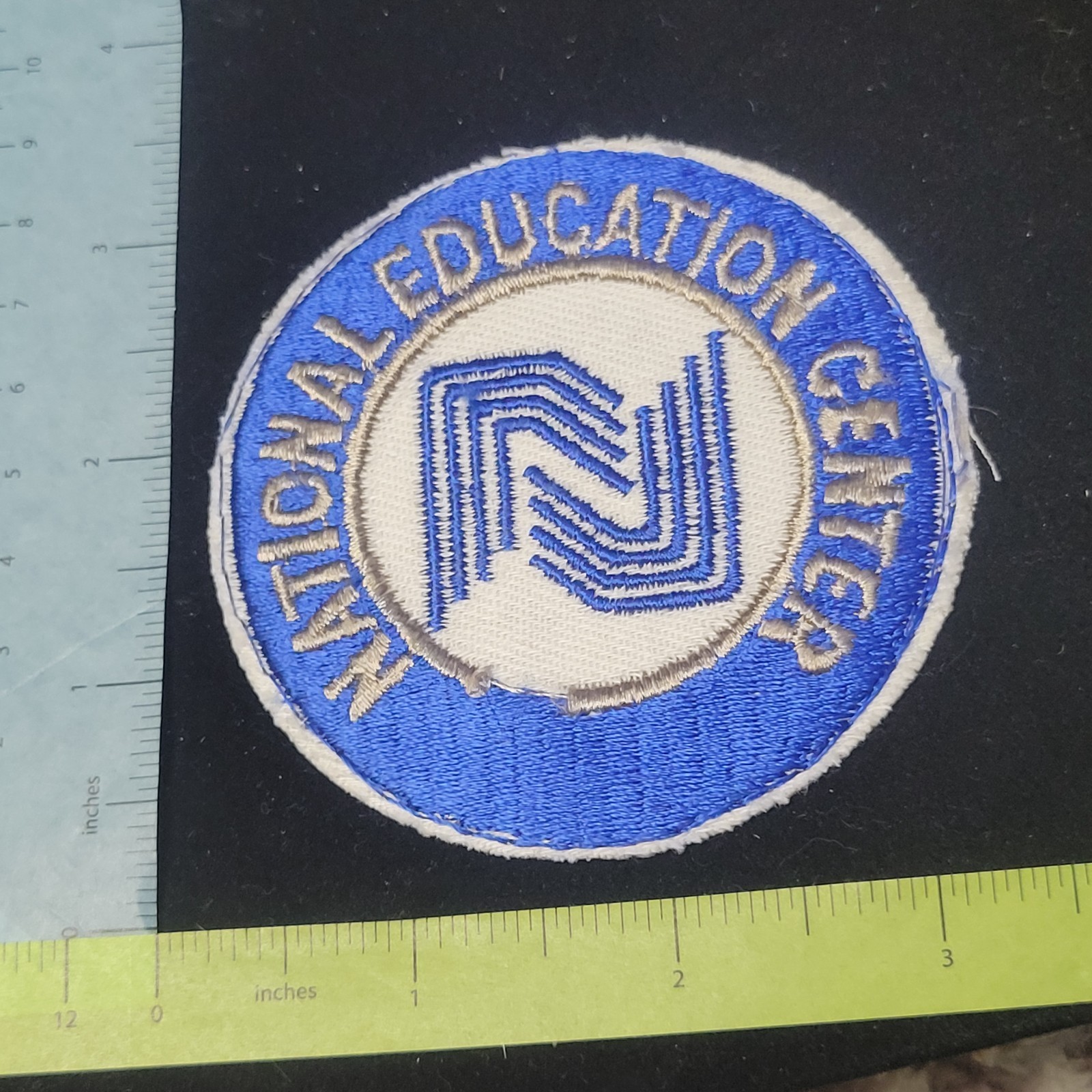 National Education Center Embroidered blue white silver patch