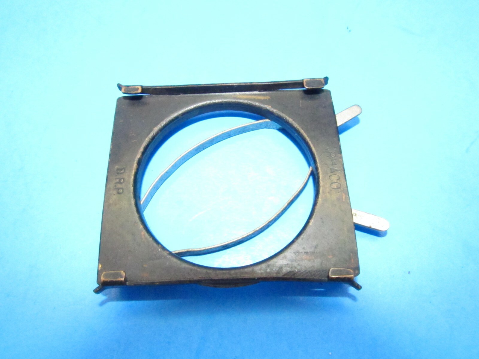 unique small filter holder marked RHACO DRP GERMANY attaches w/ spring clamps