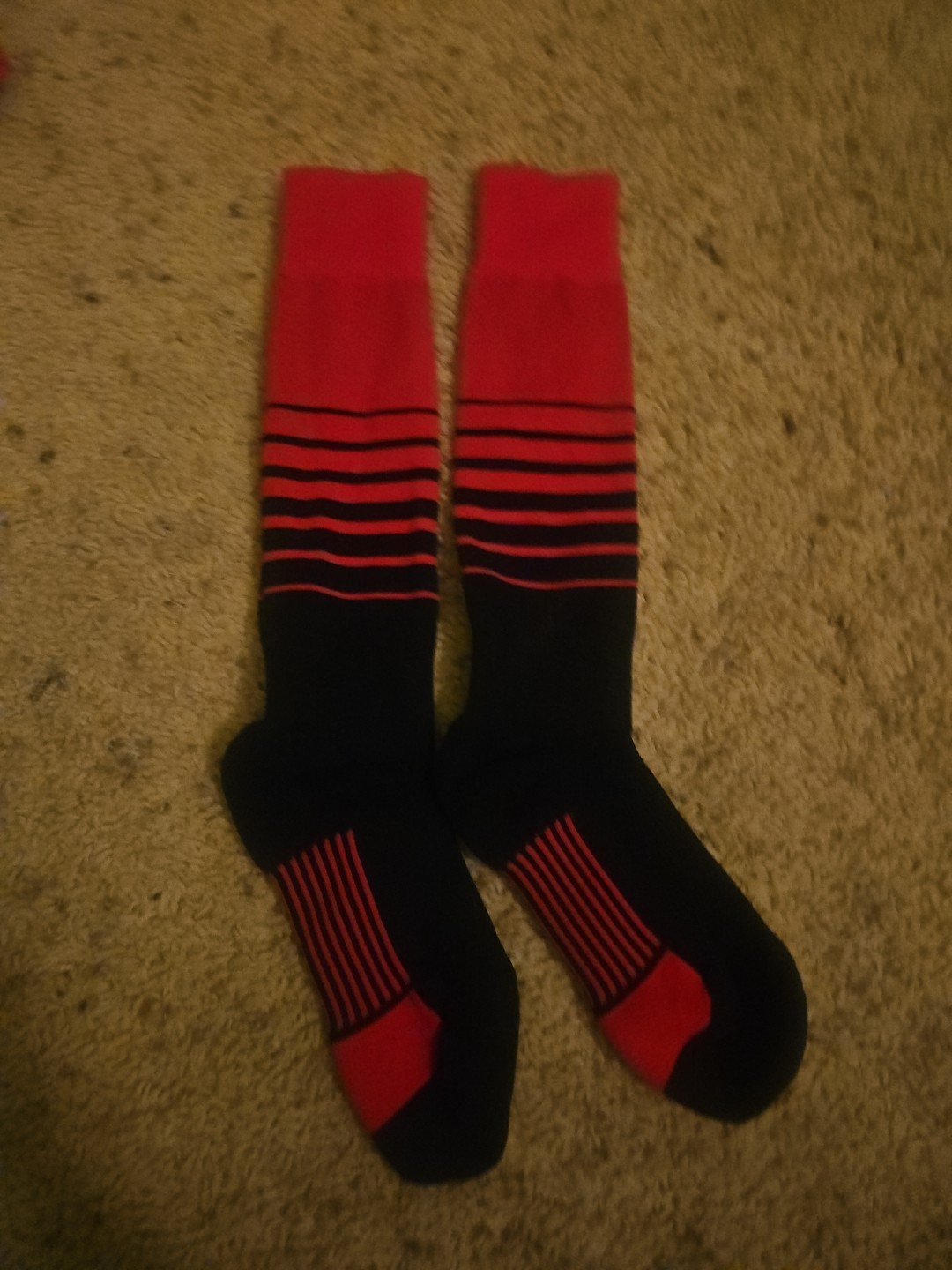 TCK Sports Elite Breaker soccer socks in red and black.