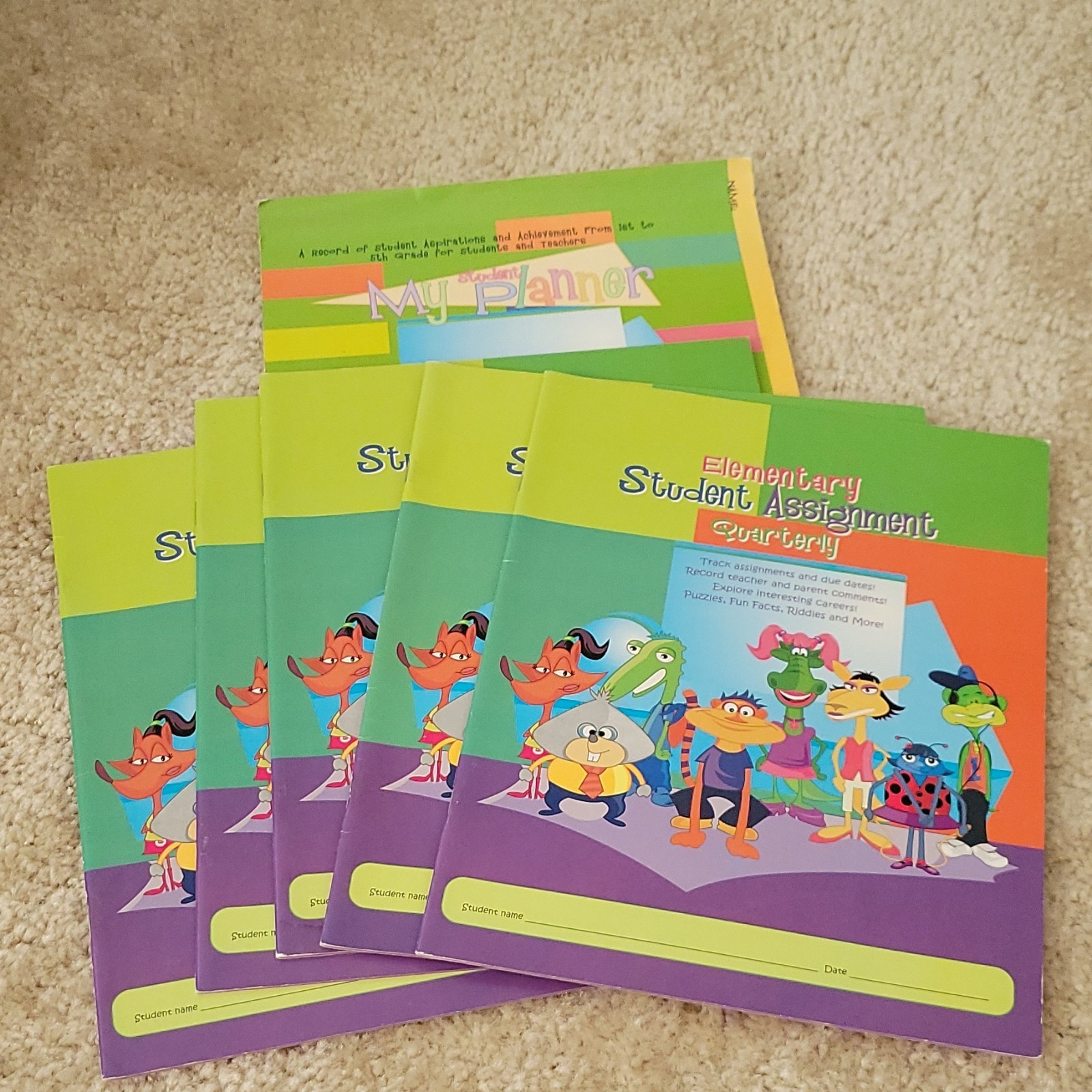 Five AES PHEAA Quarterly Assignment books, One My Student Planner Elementary