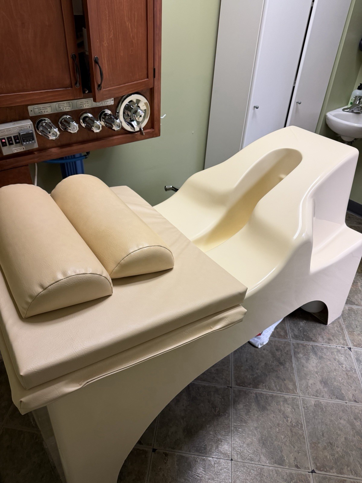 Beige Padded Examination Table w/ Stirrups, Cabinetry, Headrest, Control Panel