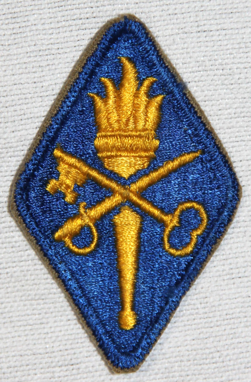 ORIGINAL EARLY CUT EDGE, WHITE BACK QUARTERMASTER SCHOOL PATCH